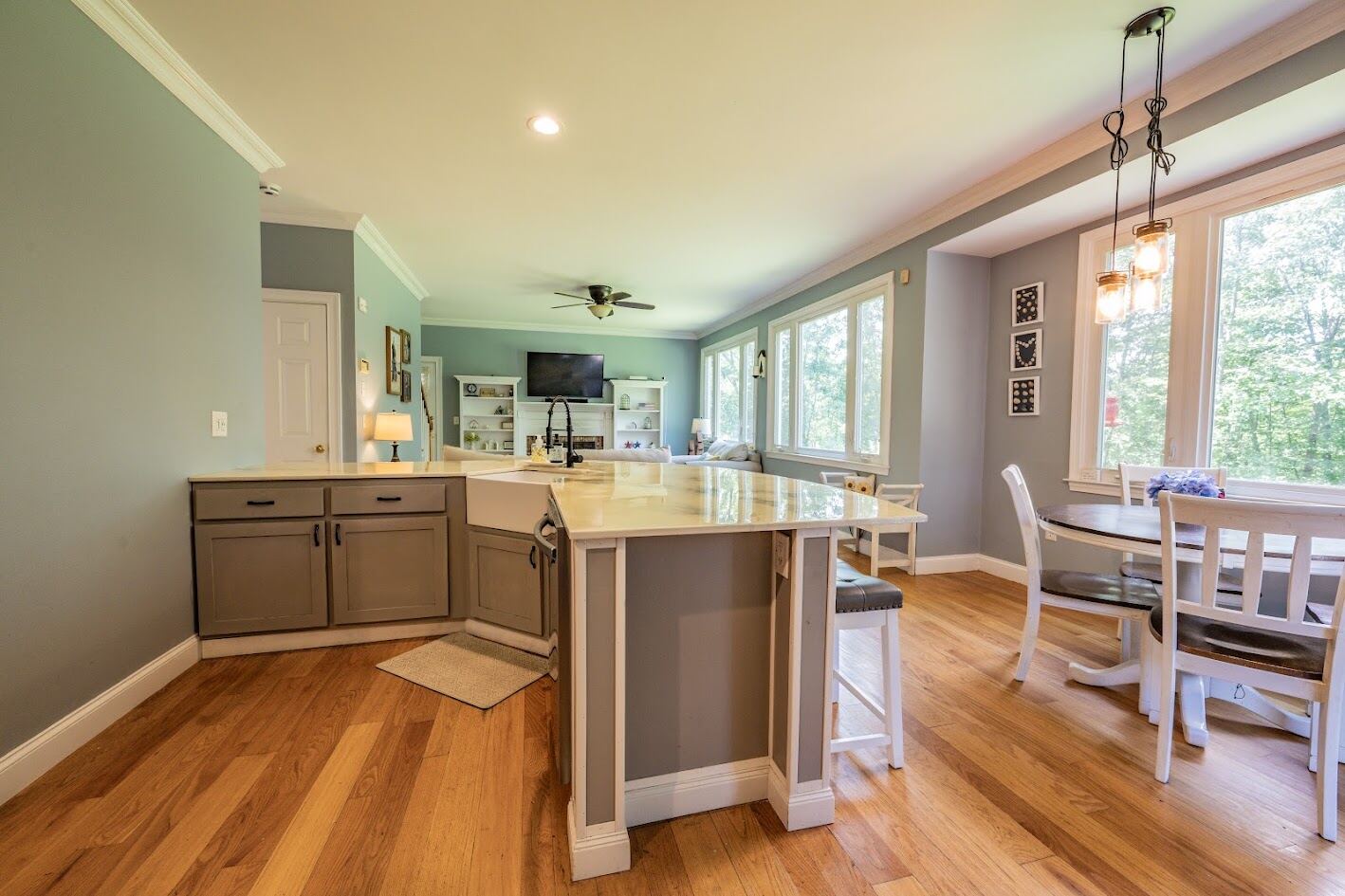Open kitchen looking through to the family room with fireplace and built-in shelving